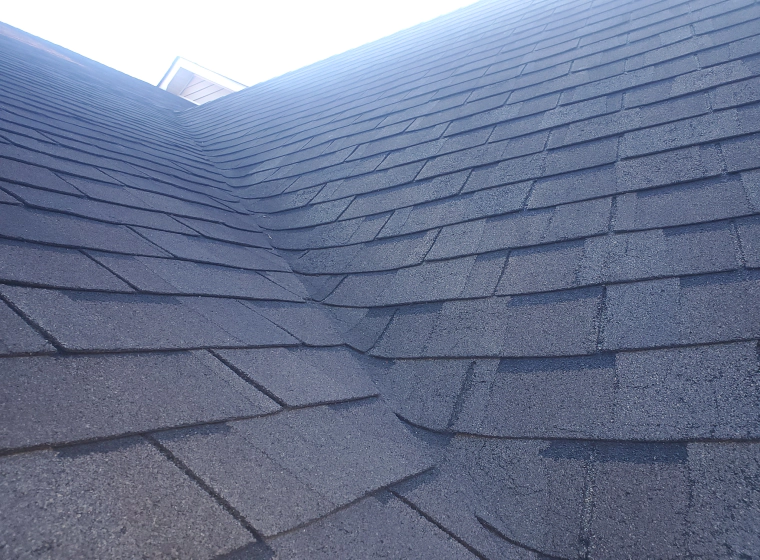 dark grey asphalt roofing of a house closeup